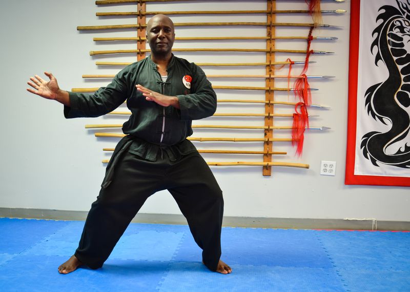 Sifu Moses holding a Tai Chi stance in his training hall